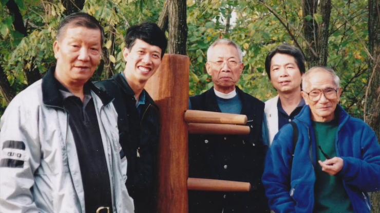Ip Ching and Ip Chun with a wooden dummy