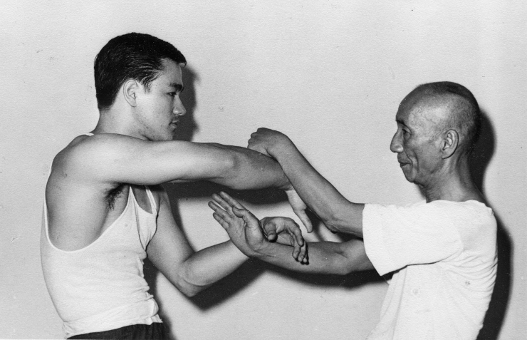 Yip Man with Bruce Lee training Chi Sao