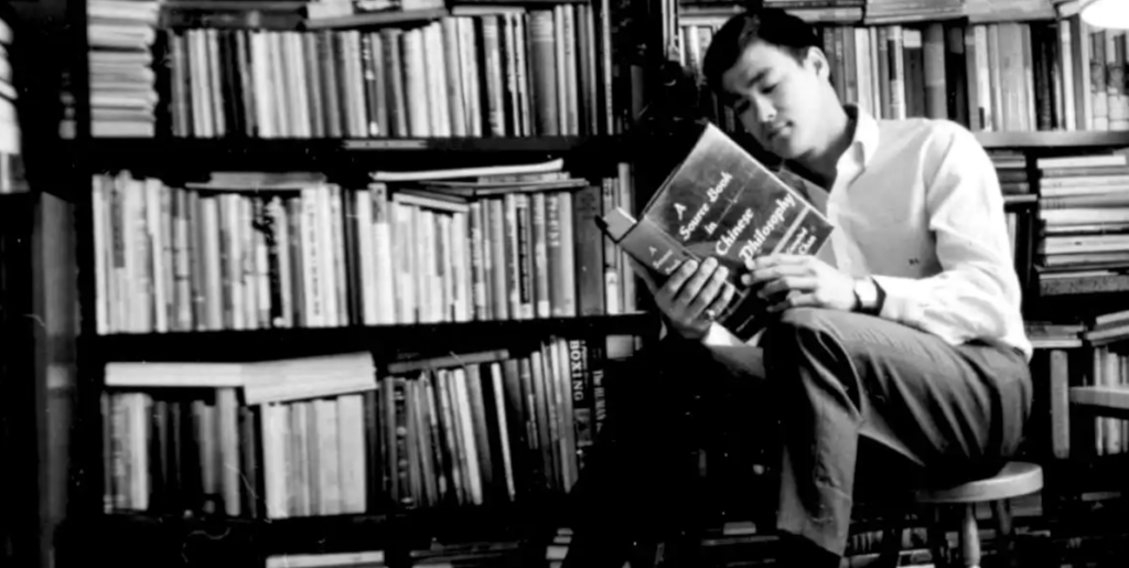 bruce lee reading a book